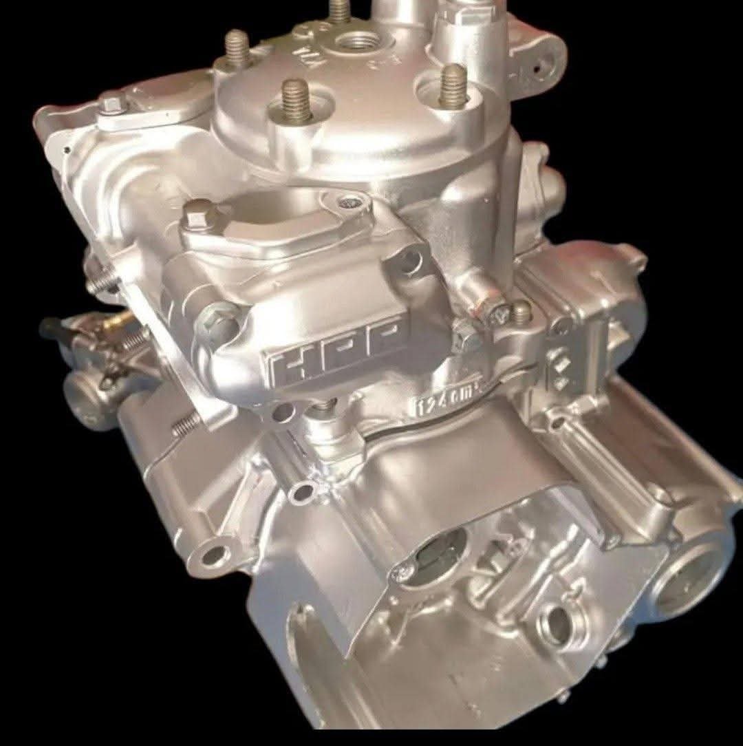 Silver polished engine block assembly with HPF branding, fuel injectors, and bolted components on black background
